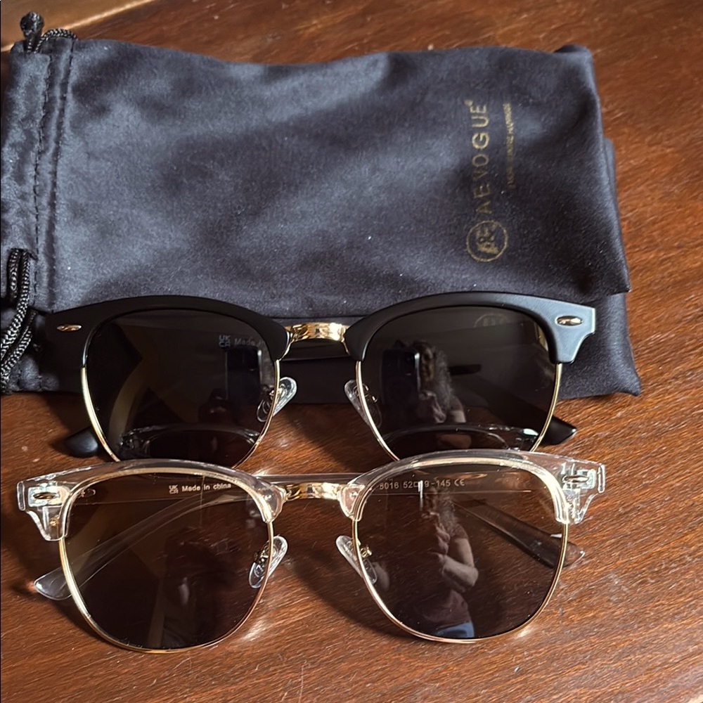 Two pair of sunglasses - one black matte/gold one clear gold.  Never worn:)